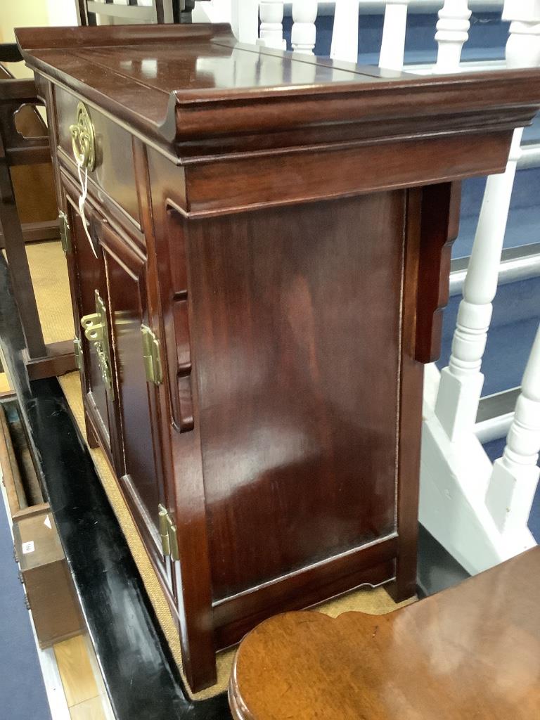 A 20th century Chinese hardwood low cabinet, with brass fitted drawer and cupboard, width 73cm depth 35cm height 72cm